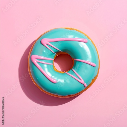 A vibrant blue glazed donut with pink icing on a pink background