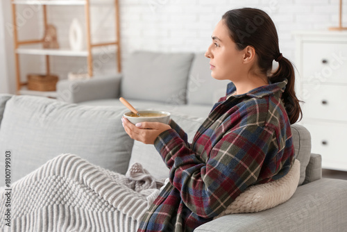 Sick young woman with plaid...