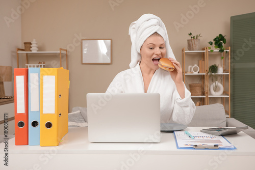 Young woman in bathrobe and...