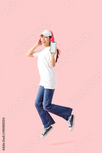 Jumping young Asian woman w...