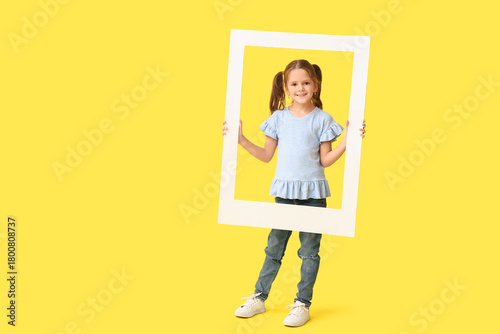 Happy little girl holding w...