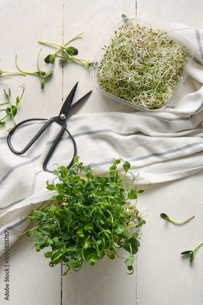 Naklejka premium Composition with fresh micro green sprouts, napkin and scissors on light wooden background