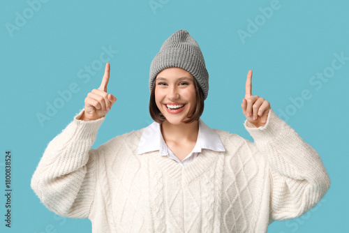 Happy young woman pointing ...