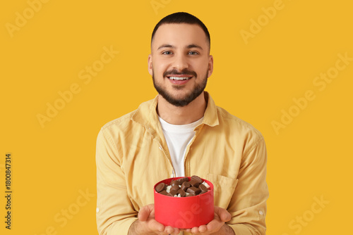 Smiling young man holding a...