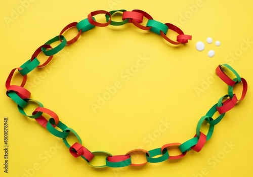 Christmas Paper Chain Garland on Yellow Background, Festive Crafting Fun