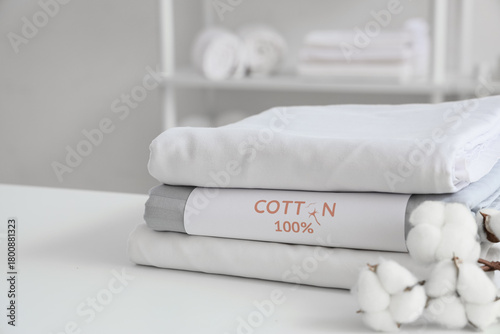 Stack of folded white and g...