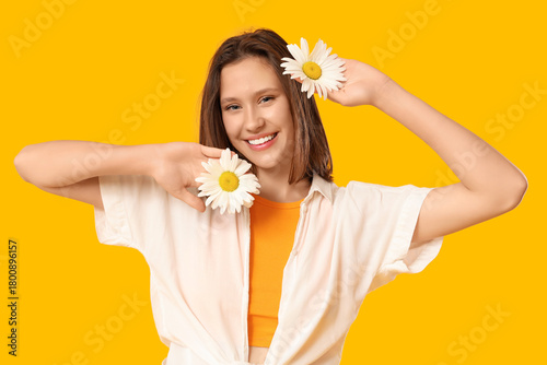 Smiling young woman holding...
