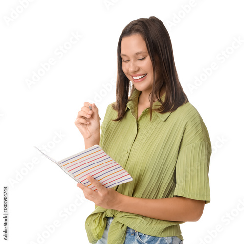 Smiling young woman writing in striped notebook with pen, education and learn...