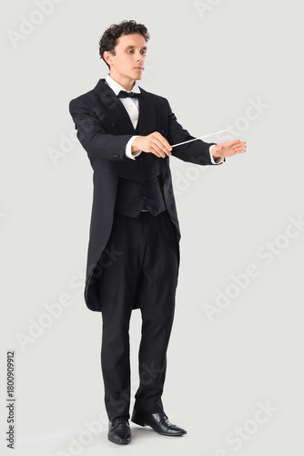 Young male conductor on gre...