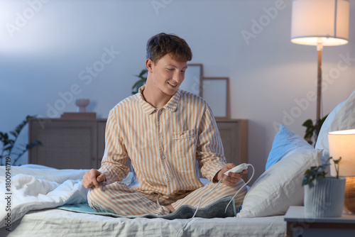 Young man turning on electr...