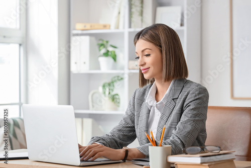 Young businesswoman using l...