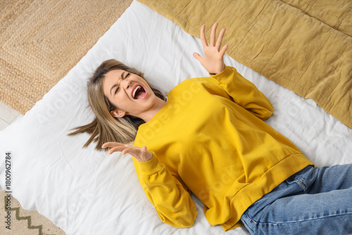 Screaming young woman lying...