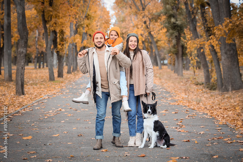 Happy family with dog in au...