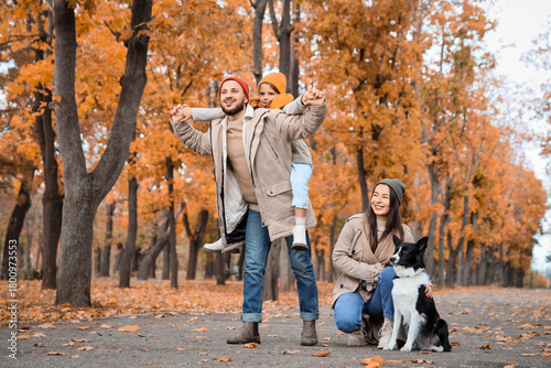 Happy family with dog in au...