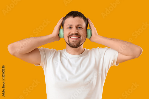 Young man in headphones lis...