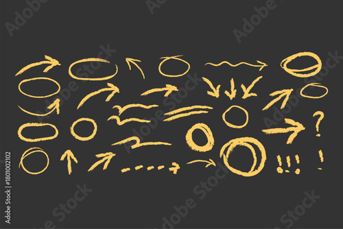 Hand drawn yellow chalk arrows and circles on dark background