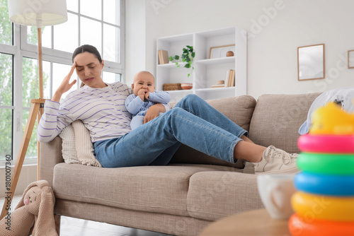 Tired mother with her baby ...