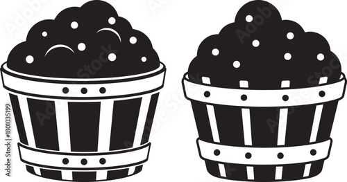 Two detailed black and white cupcake silhouettes