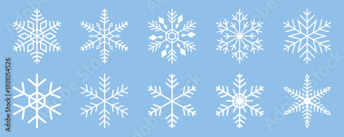 Collection of minimalist white snowflake vector icons with detailed geometric symmetry on light blue background showing winter and christmas decorative design elements