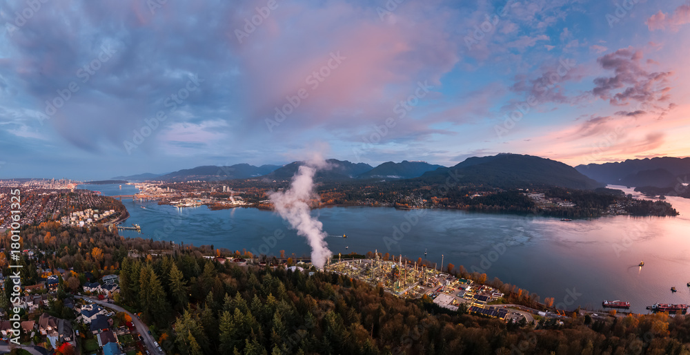 Fototapeta premium Aerial Sunset Over Burnaby City By Water With Mountains And Forest In Greater Vancouver Canada