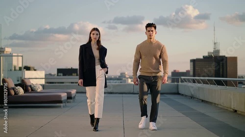 Lifestyle video of young beautiful couple model wearing designer clothing on sky lounge large balcony on warm summer evening during fashion week.Zoom in.AI Generative.