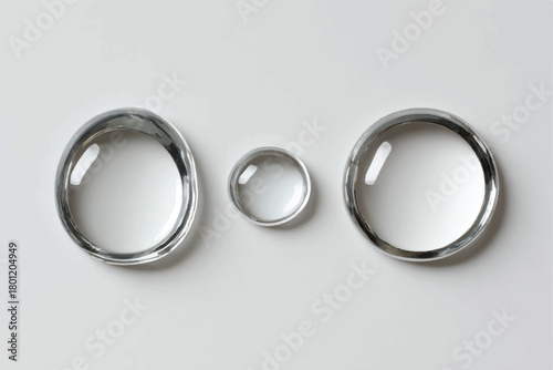 Three Clear Decorative Glass Rings on a Clean White Surface