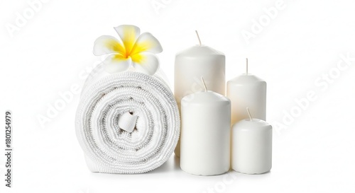 Rolled white towels with frangipani flower and candles isolated on white background