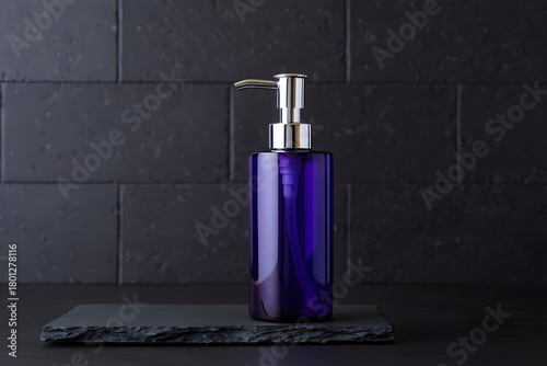 Elegant cobalt blue soap dispenser with chrome pump on dark tile