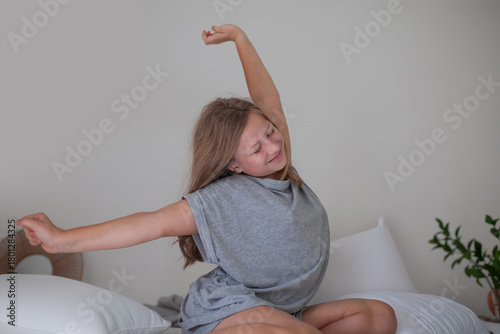 Happy Teenage Girl Relaxing in Bed in the Morning