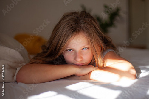 Happy Teenage Girl Relaxing in Bed in the Morning
