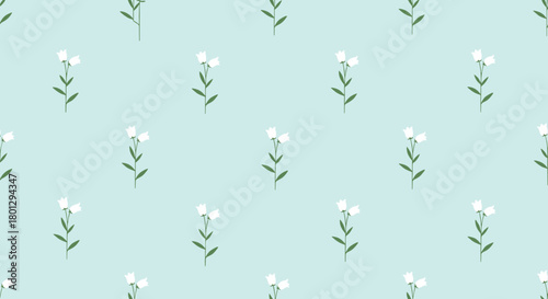 Seamless pattern featuring delicate white bellflowers with green stems evenly spaced on a soothing light blue background, for floral designs.