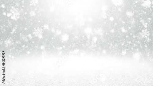 Snowflakes falling on a white background with sparkling light, perfect for winter and holiday themes.