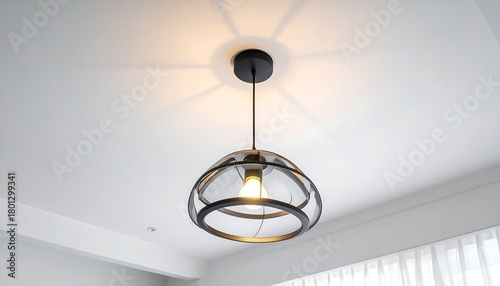 Modern pendant light fixture illuminating a bright room.