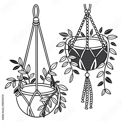 Two black and white hanging planters filled with foliage decorate a clean, empty space