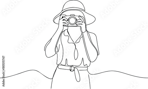Woman in hat taking photo with vintage camera photography