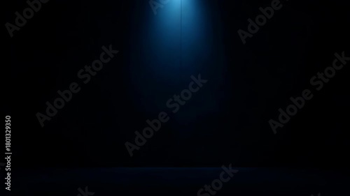 Dramatic Blue Spotlight Illuminates Empty Dark Studio Stage Floor and Wall with Moody Atmosphere and Atmospheric Haze
