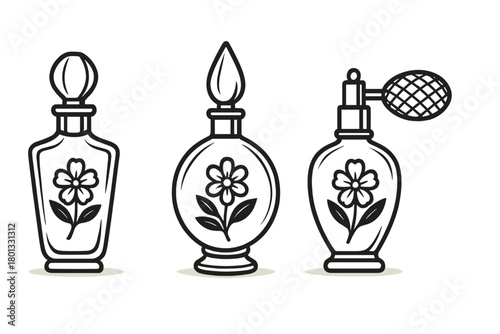 Set of three elegant vintage perfume bottles with floral decoration and various caps