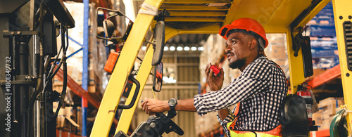 warehouse, radio, and forklift in shipping warehouse. Male transport worker in safety uniform transport worker talking on walkie talkie, drives forklift at freight cargo warehouse port.