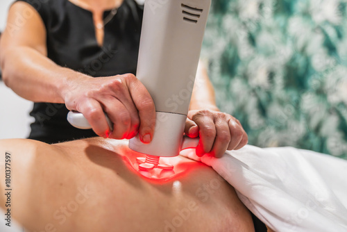 Принти на полотні Therapist applying advanced physioactive massage system to a client's back, usin