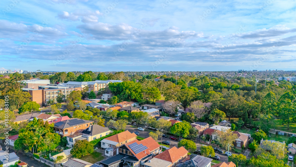 Obraz premium Aerial Panorama Drone View of a inner western Sydney Suburb of Ashbury Urban Sprawl and the terracotta roof tops streets and trees of Suburban Sydney NSW Australia