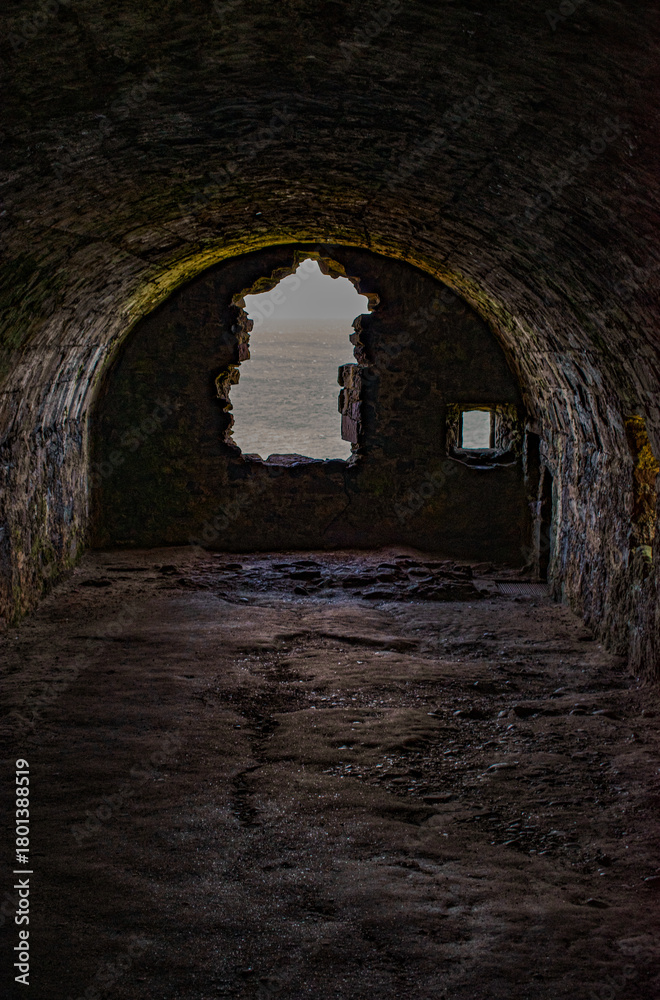 Fototapeta premium Scotland: view of the Whigs’ Vault at Dunnottar Castle, a cellar where 167 Scottish Covenanters were imprisoned in 1685 for refusing to pledge allegiance to the King as head of the church 