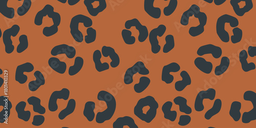 Seamless abstract leopard pattern with dark gray spots on a warm brown background, perfect for textile and fashion design