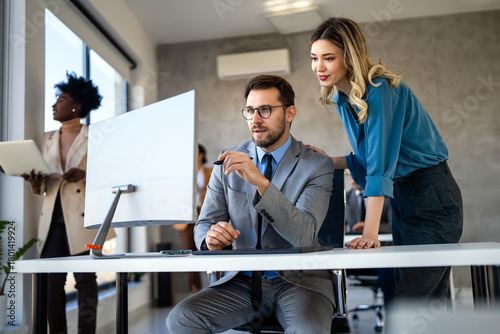 Group of multi-ethnic corporate business team collaborating on project in modern office