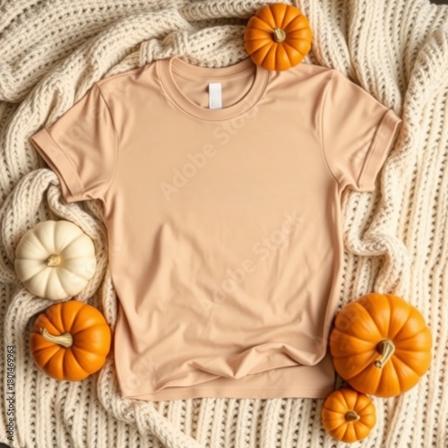 Blank tan t-shirt on knitted blanket with autumn pumpkins mockup