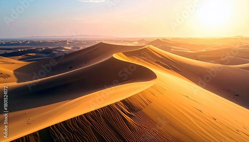 Fototapeta Naklejka Na Ścianę i Meble -  Vast desert landscape with rolling sand dunes bathed in the warm glow of a setting sun.