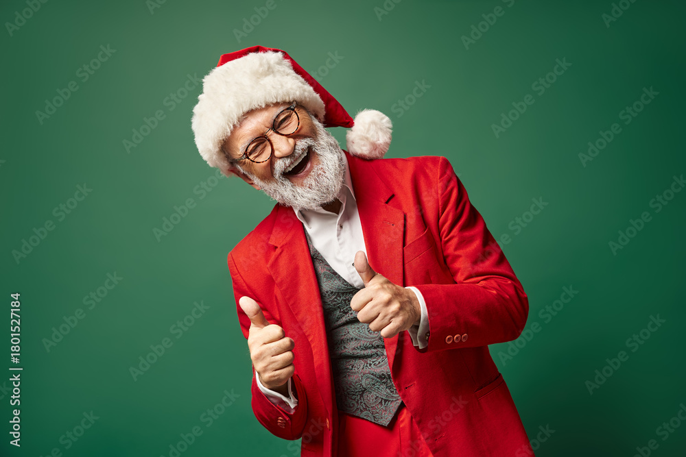 Naklejka premium Joyful senior man in a festive red suit celebrating winter cheer