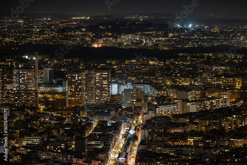 Aerial view of a sprawling cityscape ablaze with golden light, revealing the distinct silhouettes of buildings and the dark paths of streets, Paris, Ile-de-France, France.