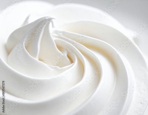 Macro photograph of a creamy, swirling white texture, resembling soft-serve ice cream or whipped cream
