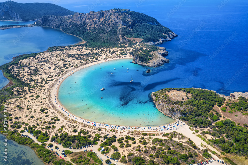 Obraz premium Aerial view of the half circle shaped Voidokilia beach in Messinia, Peloponnese, Greece, with sand dunes and turquoise sea