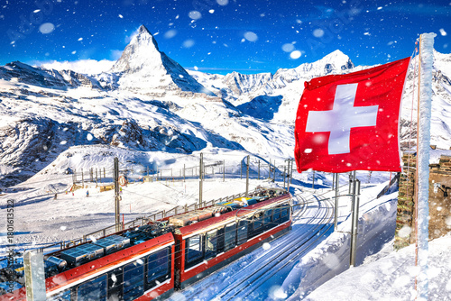 Matterhorn and Gorngerat cogwheel railway station in Zermatt ski area with Swiss flag view